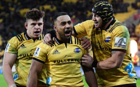 Hurricanes Ngani Laumape, centre,  celebrates scoring a try with team mates Ricky Riccitelli, left, and Jeff Toomaga-Allen.