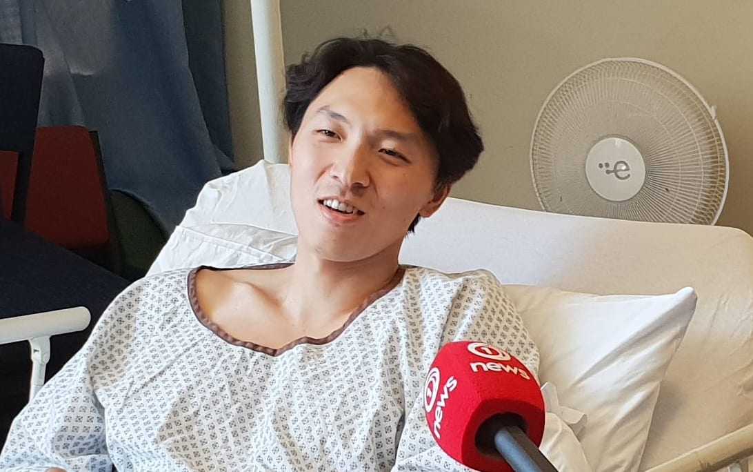 Son Jungho talks to media from his hospital bed.