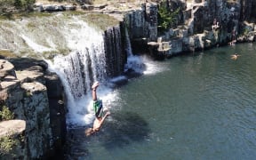 Tommy Lodge backflips from the top of the falls at Charlie’s Rock, on Kerikeri’s Waipapa River.