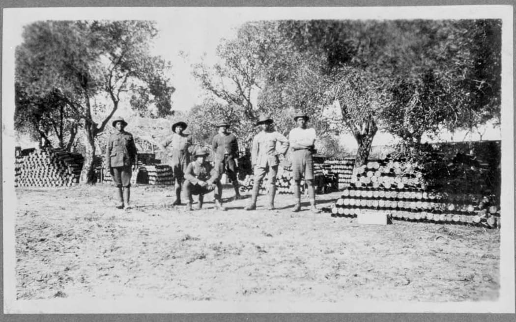 Rarotongan soldiers standing next to artillery shells, about 1916-18