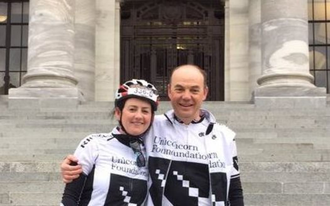 Dr Malcolm Legget with Unicorn NZ charity founder Siobhan Conroy on the steps of Parliament after a cycle tour to raise funds for a new scanner.