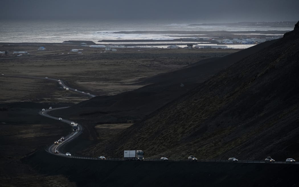 This photo, taken on 13 November, 2023 shows vehicles leaving the town of Grindavik, southwestern Iceland, during evacuation following earthquakes. The southwestern town of Grindavik - home to around 4,000 people - was evacuated in the early hours of 11 November after magma shifting under the Earth's crust caused hundreds of earthquakes in what experts warned could be a precursor to a volcanic eruption.
