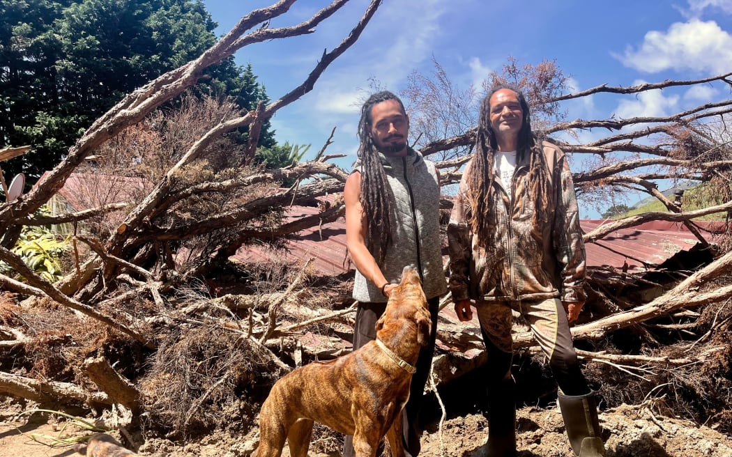 Seldom and David Torrey and pets stand beside home, which they are displaced from after severe weather last month.
