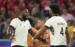 Fiji's Isoa Nasilasila, right, and Temo Mayanavanua celebrate victory over Australia in their Rugby World Cup Pool C match in Saint-Etienne, south-eastern France on 17 September 2023.
