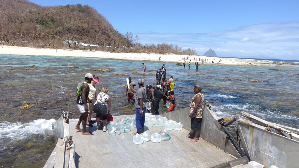 There was no way to reach the beach so the Epi Dream captain dropped the ramp on the barrier reef precariously holding the barge in position and away from the dangerous coral.