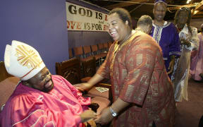 Archbishop Carl Bean is greeted by church member Armond Anderson-Bell during the service Sunday, Oct. 10, 2004.