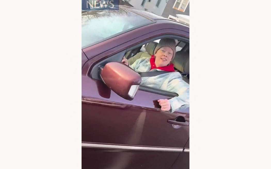 This screen grab of vertical video footage apparently taken by an officer with the Immigration and Customs Enforcement agency (ICE) and provided by Alpha News on January 10, 2026 shows him interacting with a woman, Renee Nicole Good, on January 7, 2026 moments before she was shot and killed by an ICE agent in Minneapolis, Minnesota. A US Immigration and Customs Enforcement (ICE) agent shot and killed the American woman on the streets of Minneapolis January 7, leading to huge protests and outrage from local leaders who rejected White House claims she was a domestic terrorist. The woman, identified in local media as                                          37-year-old Renee Nicole Good, was hit at point blank range as she apparently tried to drive away from agents who were crowding around her car, which they said was blocking their way. (Photo by HANDOUT / ALPHA NEWS / AFP) / - NO Marketing campaign / - NO MARKETING CAMPAIGN /  - NO MARKETING CAMPAIGN / === RESTRICTED TO EDITORIAL USE - MANDATORY CREDIT "...