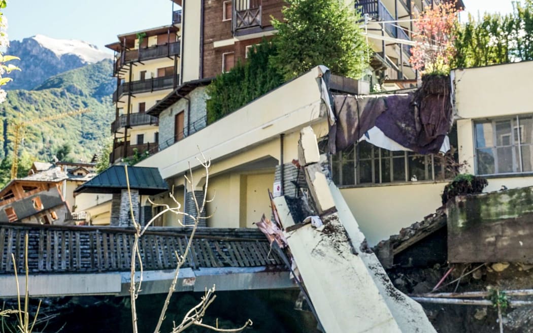 This photo taken on October 3, 2020 and provided by Italian news agency ANSA shows a block  of concrete that collapsed from a building in a watercourse following bad weather and floods in Limone Piemonte, near Cuneo, Piedmont.