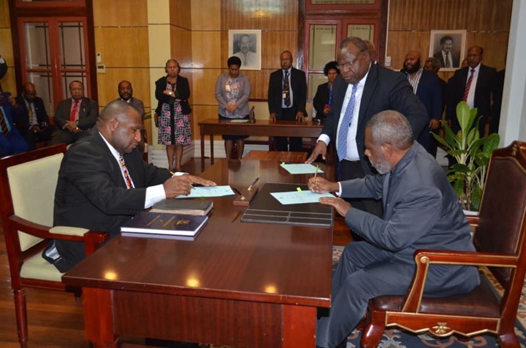 James Marape left being sworn in as prime minister of Papua New Guine by the governor general Sir Robert Dadae. 30 May 2019
