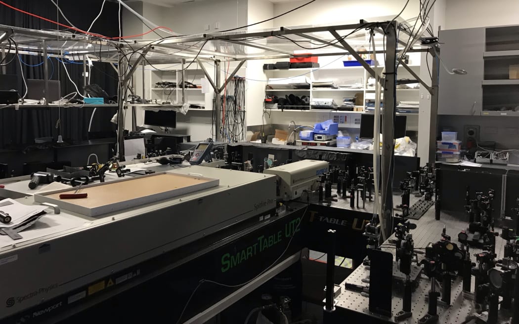 A lab with lab benches and lots of electronic equipment including lasers.