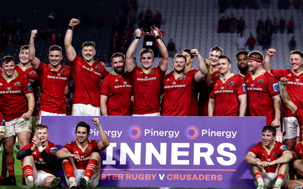 The Munster team celebrate with the Clash Of Champions Cup.