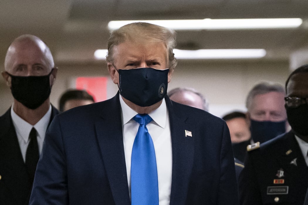 US President Donald Trump wears a mask as he visits Walter Reed National Military Medical Center in Bethesda, Maryland.