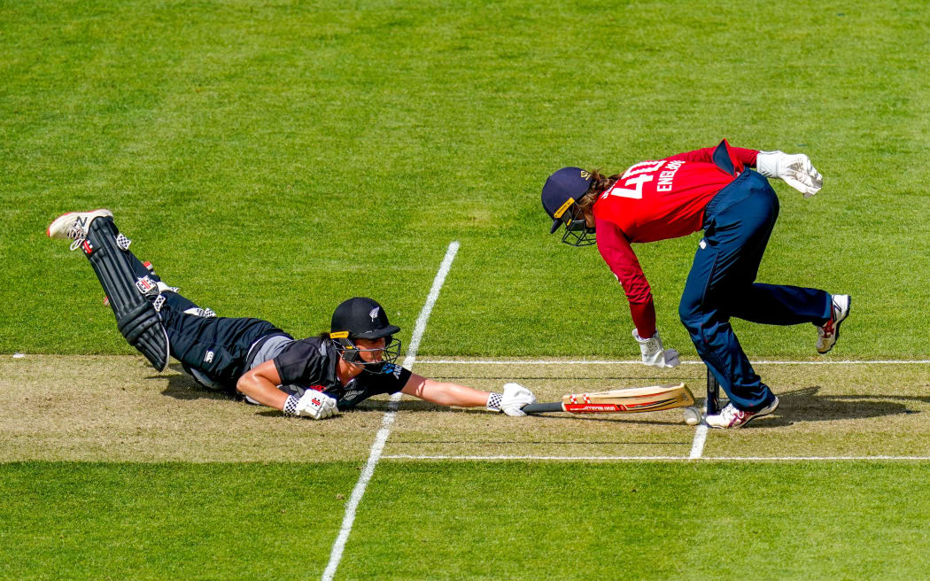 White Fern's Katey Martin slides in against England 2021.