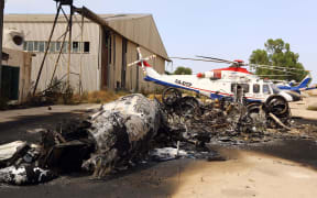 The charred remains of a plane at  Tripoli aiport following an attack on Monday.