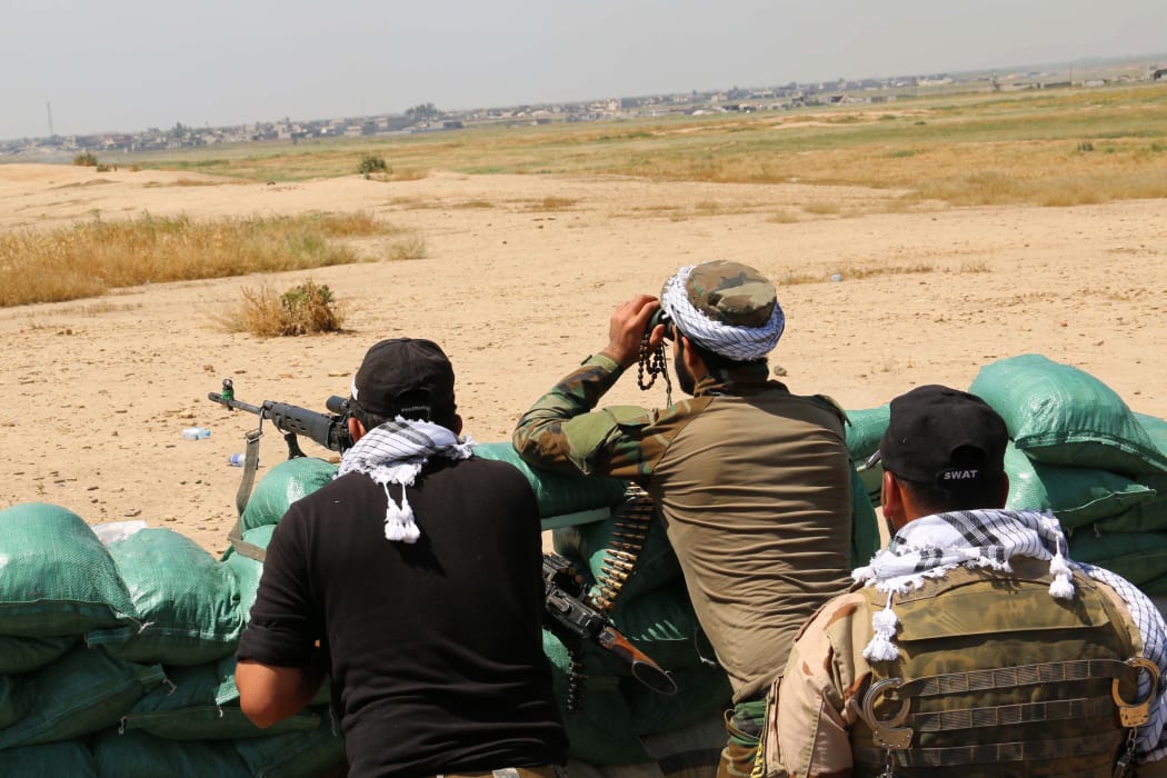 Iraqi Kurdish Peshmerga forces and al-Hashd al-Shaabi factions hold a position, about 250 km north of Ramadi, on 18 April.