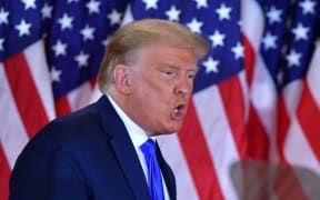 US President Donald Trump gestures after speaking during election night in the East Room of the White House in Washington, DC, early on November 4, 2020. (Photo by MANDEL NGAN / AFP)