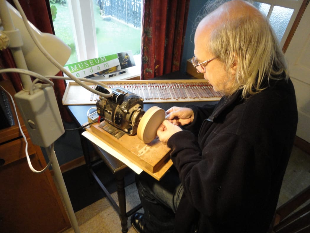 Auckland harpsichord maker and technician Paul Downie working painstakingly on some of the 305 jacks of The Beast.
