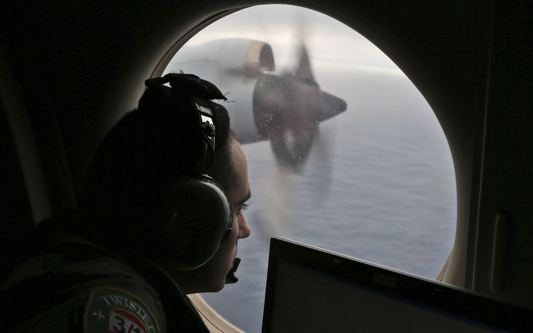 A crew member on a Royal Australian Air Force AP-3C Orion searches for missing Malaysia Airlines flight MH370 in the southern Indian Ocean in 2014.