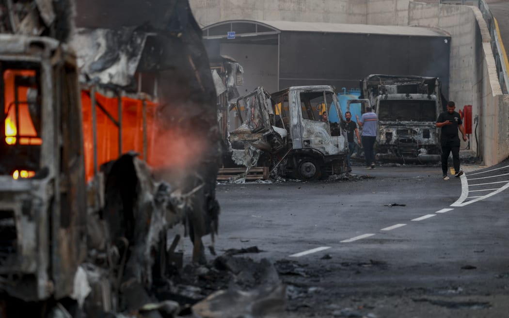 Burnt trucks after an attack by Israeli settlers in the village of Beit Lid, east of Tulkarm in the occupied West Bank, on November 11, 2025. Violence in the West Bank has surged since the outbreak of the Gaza war in October 2023, with frequent settler assaults on Palestinian towns and property. (Photo by Mohammad Nazal / Middle East Images via AFP)