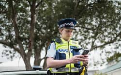 A police officer uses the digital notebook on their phone.