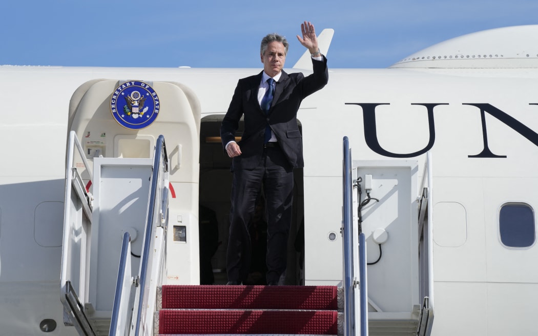 US Secretary of State Antony Blinken waves as he boards a plane, October 11, 2023, at Joint Base Andrews, Maryland, en route to Israel. President Joe Biden is dispatching his top diplomat to Israel on an urgent mission to show US support after the unprecedented attack by Hamas militants. (Photo by Jacquelyn Martin / POOL / AFP)
