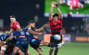 Ryan Louwrens of the Rebels kicks under pressure from Scott Barrett of the Crusaders during the Super Rugby Pacific match, Crusaders Vs Rebels, at the Apollo Projects Stadium, Christchurch, New Zealand, 26th April 2024. Copyright photo: John Davidson / www.photosport.nz