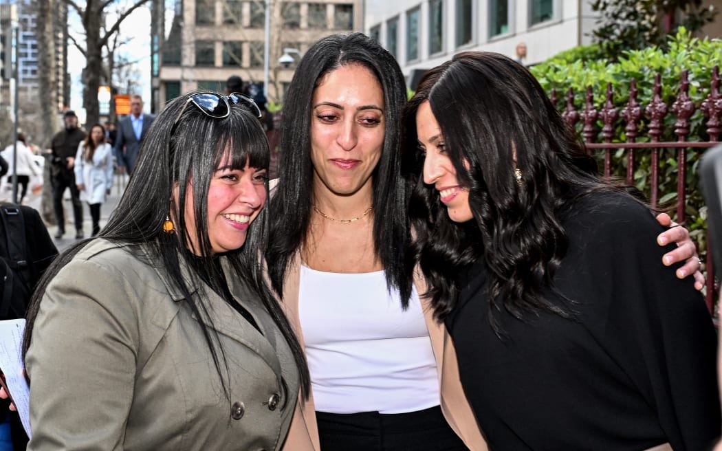 Sisters Dassi Erlich (L), Elly Sapper (C) and Nicole Meyer embrace outside the County Court in Melbourne on August 24, 2023, after ex-headmistress Malka Leifer was sentenced to 15 years in jail for sexually abusing Dassi and Elly at an Australian Jewish school, before fleeing to Israel then being extradited back. (Photo by William WEST / AFP)