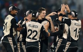 New Zealand bowler Mitchell Santner, centre, celebrates the wicket of India's Rohit Sharma during the World T20 match in Nagpur on 15 March 2016.