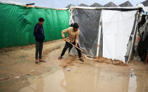 Palestinians are taking refuge amid the rain at a camp for displaced people in Deir El-Balah, in the central Gaza Strip