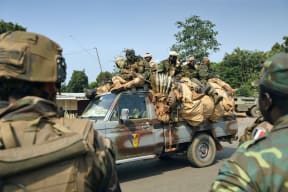 Soldiers from Chad drive past French soldiers in Bangui.