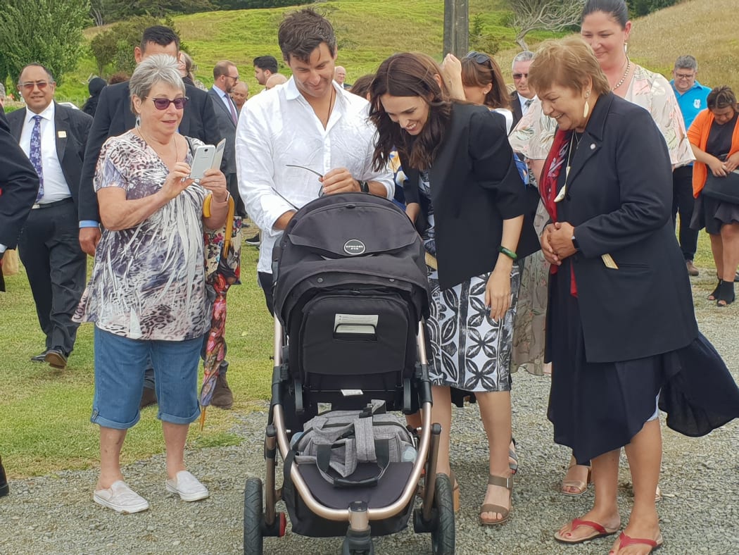 PM and partner Clarke Gayford check on baby Neve alongside members of Otematea Marae at Kaipara.