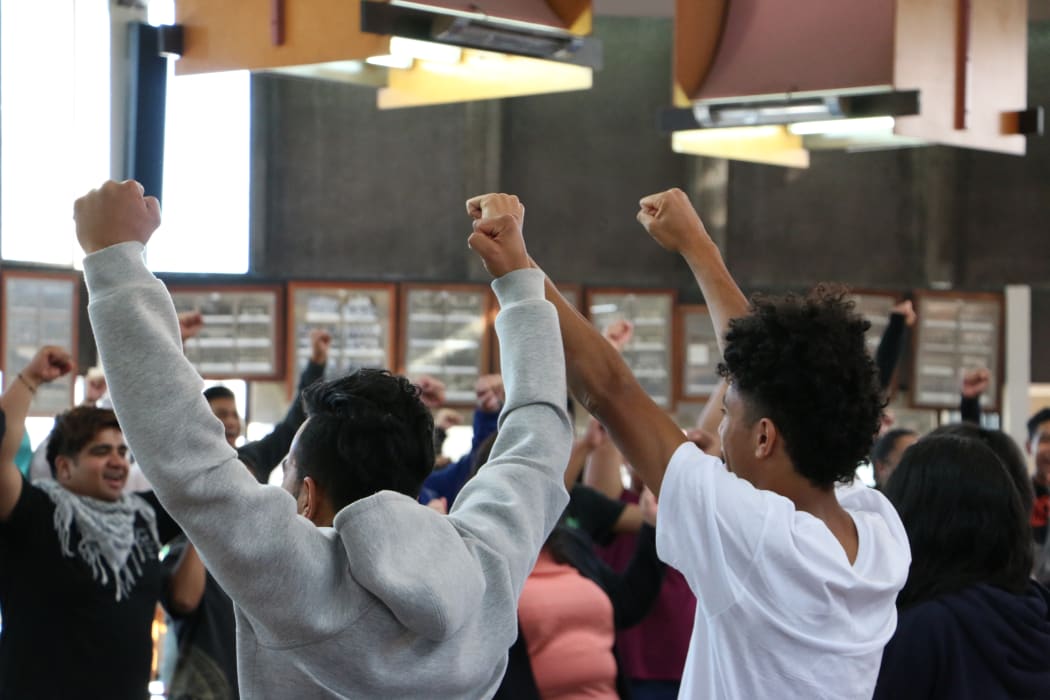 Pacific youth in Christchurch take part in a warm up game of rock, paper, scissors before question time at the Pacific Youth Parliament simulation.