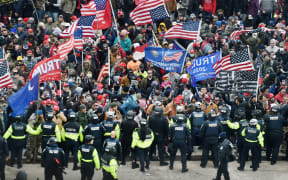 Trump supporters clash with police and security forces as they storm the US Capitol in Washington, DC on January 6, 2021.