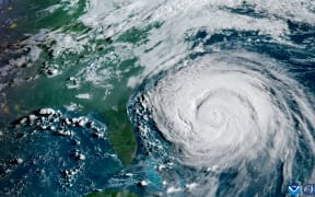 This satellite image provided by the National Oceanic and Atmospheric Administration (NOAA) shows Hurricane Erin looming of the US East Coast on August 20, 2025.