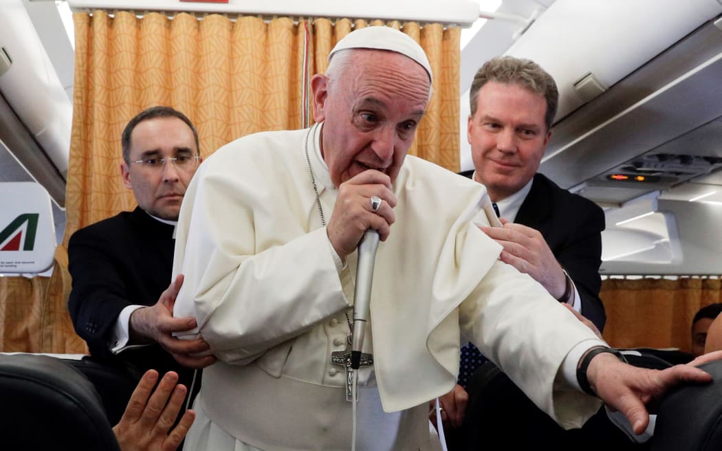 Pope Francis speaks to the press from aboard his plane on April 29, 2017, on his return flight from Cairo to Rome.
