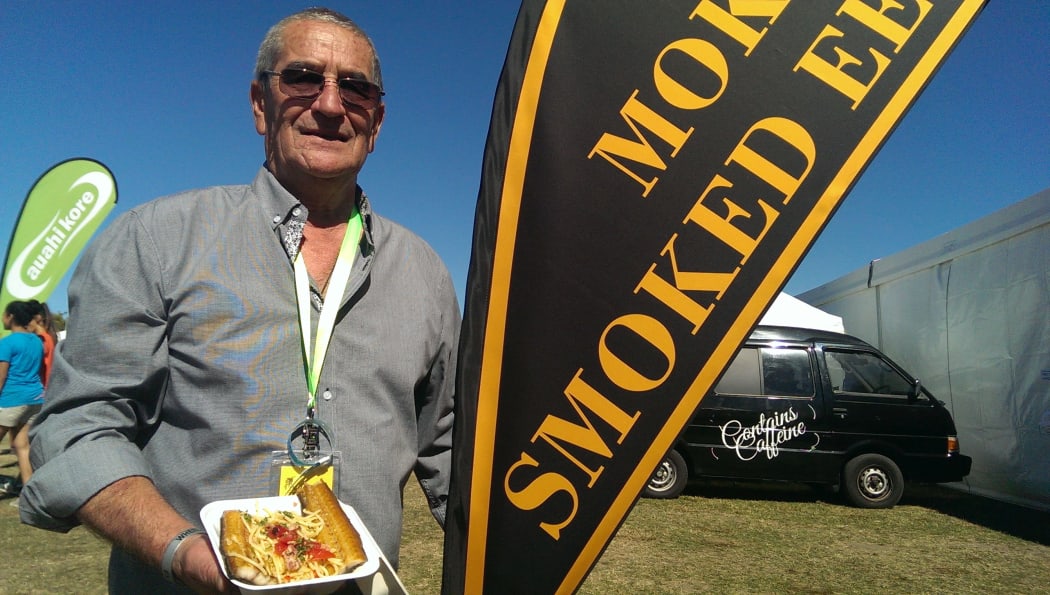 Robert Dawson holding a meal of traditionally cooked eel.
