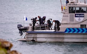 Police dive at Karaka Bay after discovering the body of a diver that went missing