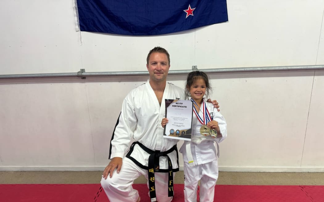 Vana Smith took home a gold in patterns and a silver in sparring, beating a taller, older, and higher graded opponent, according to her coach Ben Evan (left).