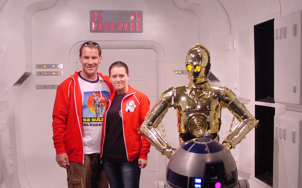 Matt and Kristy Glasgow with C3PO and R2D2 at Star Wars celebration.