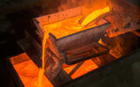 Casting gold at a factory. Gold mining.