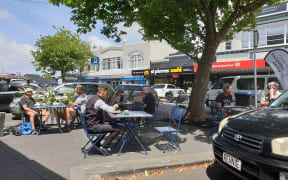 Enjoying the sun in Ponsonby on the first day of the red traffic light setting.