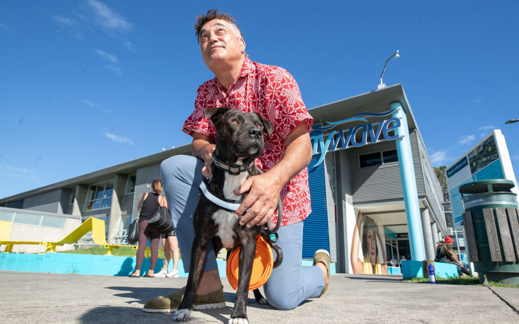 Jarrod Tumai with his dog Poto, who is no longer allowed at council pools