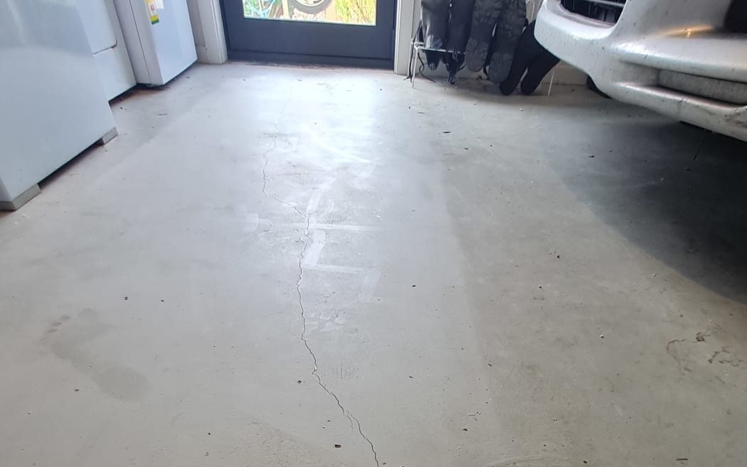 A crack in the garage floor caused by the quake.