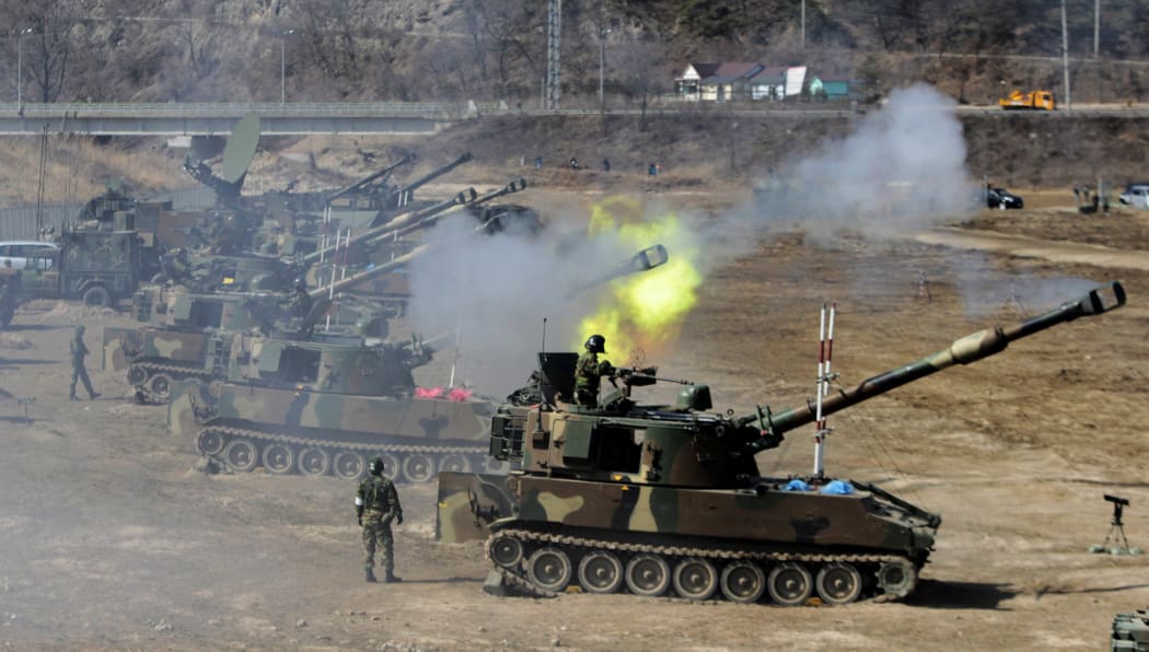 South Korean army K-55 self-propelled howitzers participate in a live fire drill during the annual South Korea-Us joint maneuvers, known as Foal Eagle, near Rodriguez Range in Pocheon, south of the demilitarized zone that divides the two Koreas, on March 15, 2012.