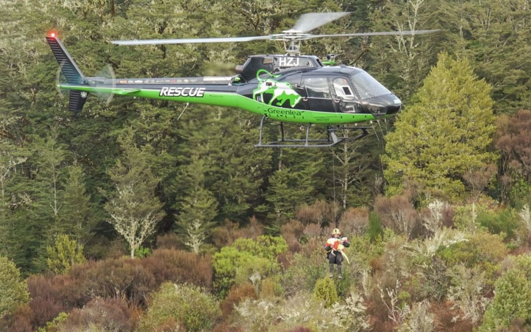 A hunter and his dog are winched to safety.