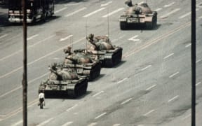 A Beijing demonstrator blocks the path of a tank convoy along the Avenue of Eternal Peace near Tiananmen Square. For weeks, people have been protesting for freedom of speech and of press from the Chinese government.