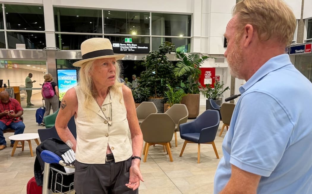 German tourist Ursula Daus confronts a Coral Expedition representative after the liner ran aground.