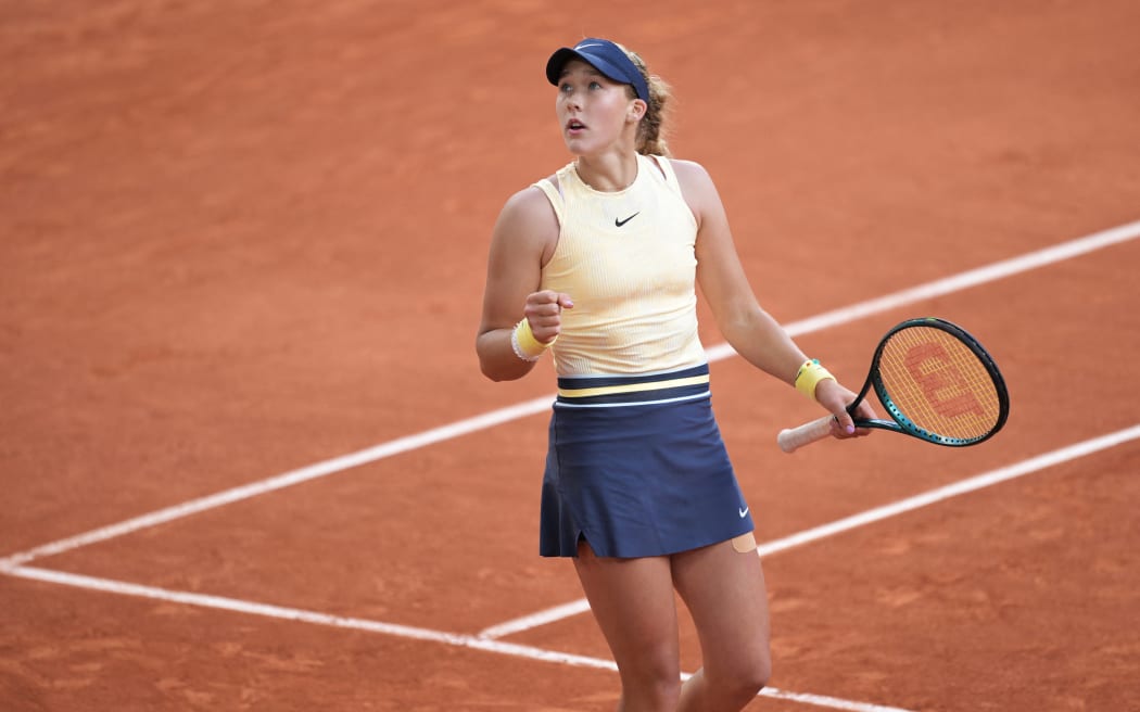 Russia's Mirra Andreeva celebrates after winning against Belarus' Aryna Sabalenka in the women's singles quarter final match at the French Open tennis tournament at the Roland Garros Complex in Paris, 2024.