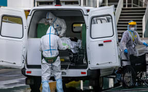 Medical staff members carry out from an ambulance a person at the Covid-19 infected patients section at the Kommunarka Hospital outside Moscow on October 15, 2021.
