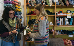 Katie Minett and Tash Barneveld inside the Holland Road Yarn Company look at their yarn products.
